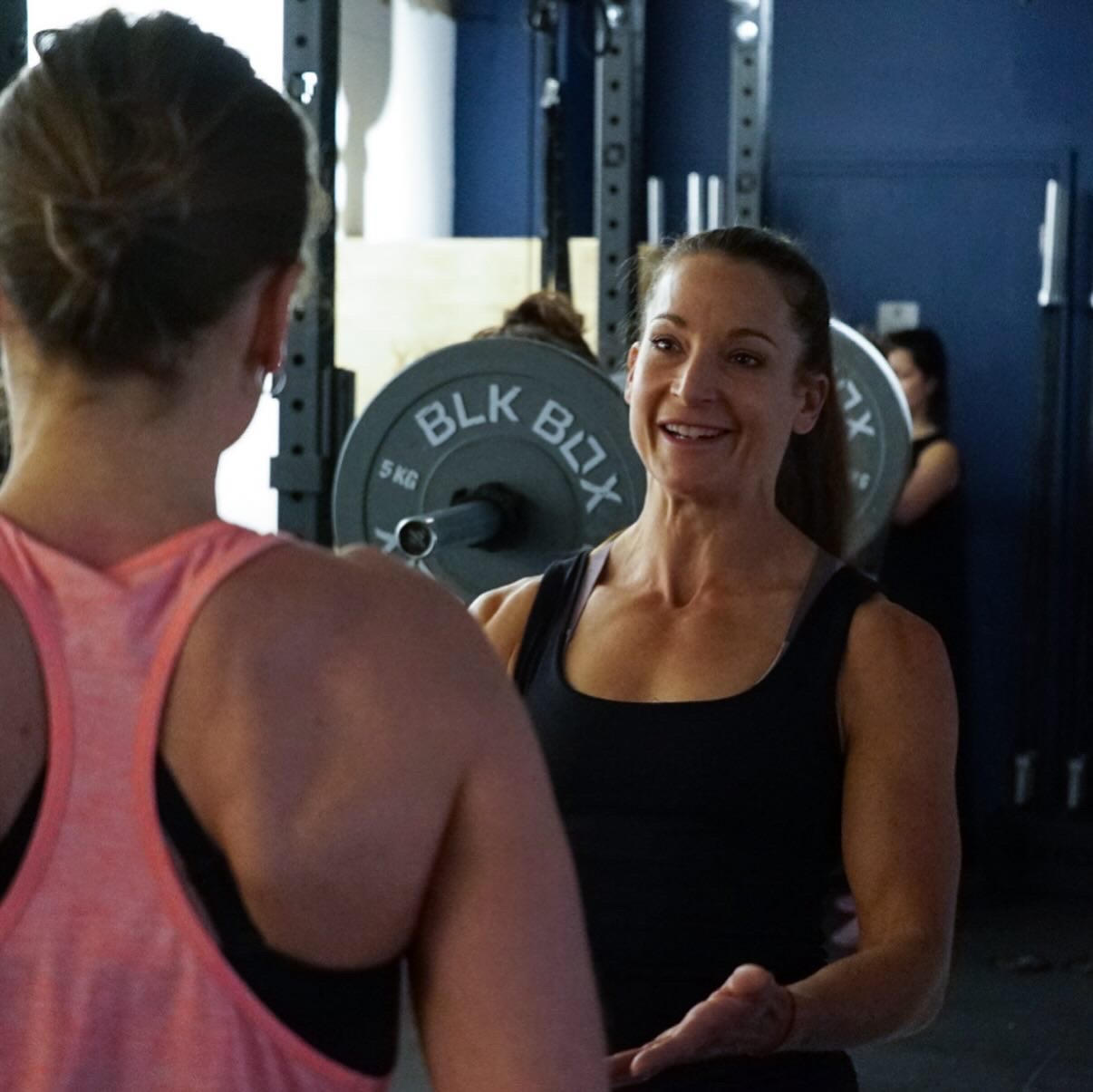Liz Marsland, bridal and wedding fitness personal trainer, coaching a client in the gym