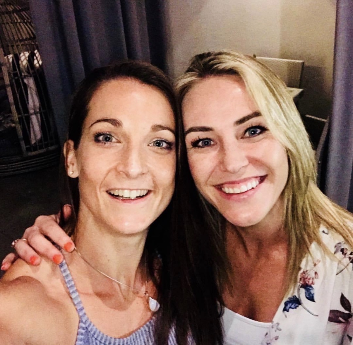 Liz smiling in a selfie with a friend and client